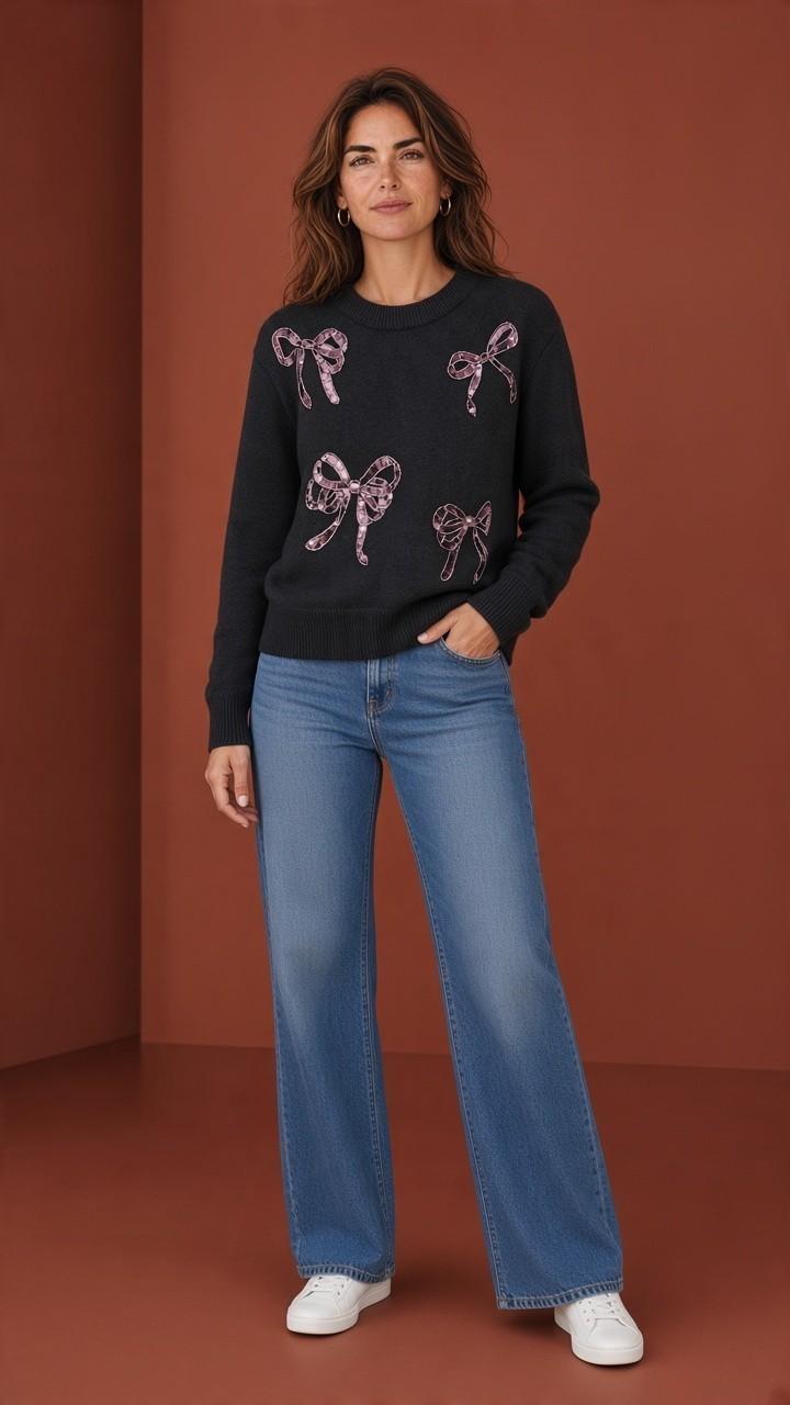 Black sequin bow crewneck sweater styled with blue jeans.