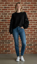 Black Sequin Sleeve Sweater - Full length view on model against brick wall