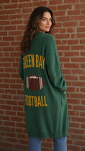 Back of green cardigan with yellow Green Bay Football lettering and football graphic