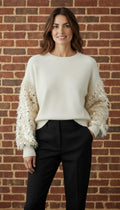 Ivory Sequin Sleeve Sweater - Front view on model against brick wall