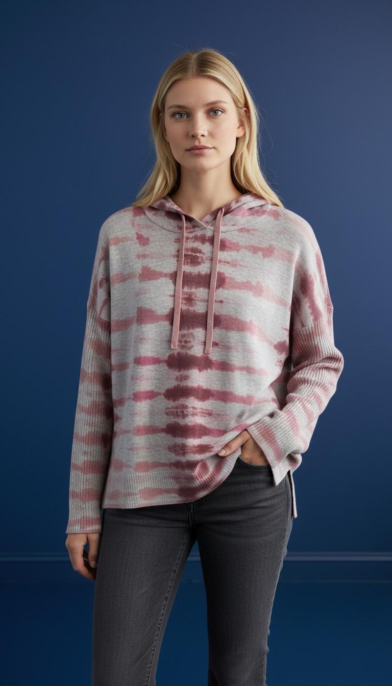 Model wearing a mauve, blush, and cream tie-dye hooded knit top