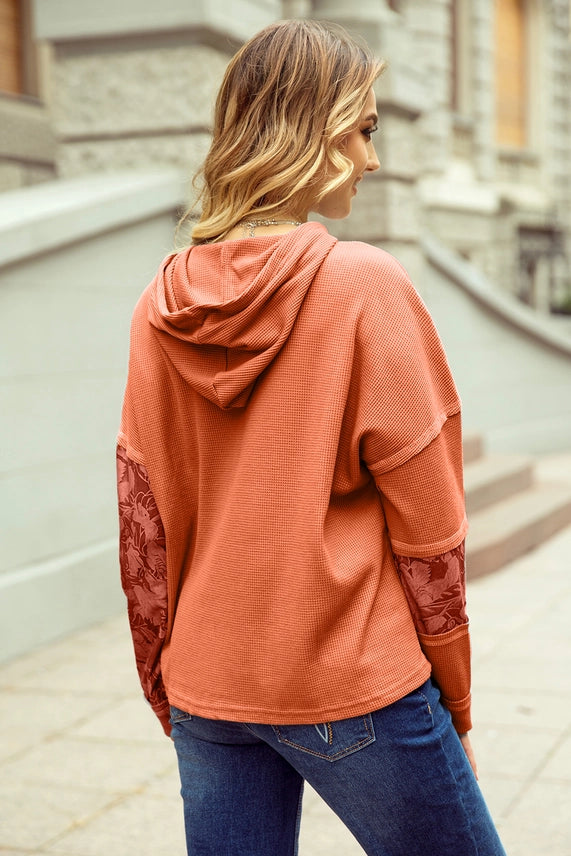 Cinnamon waffle-knit hoodie with floral jacquard sleeve panels, back view
