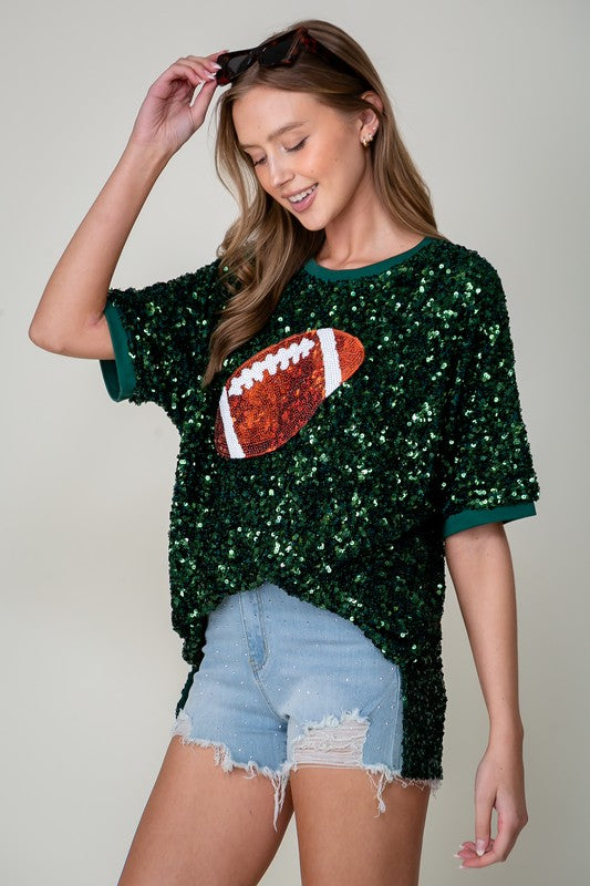 Model wearing green sequin football top, full body view