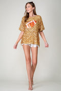 Model wearing gold sequin football top, full body front view