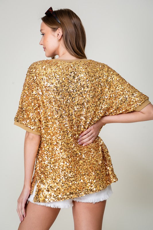 Model wearing gold sequin football top, back view