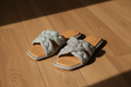 Very G Twisty 2 Crystal Braided Slide Sandal on wood floor