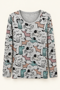 Gray long-sleeve dog-print top with stone accents against a studio backdrop