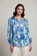 Model wearing blue watercolor floral blouse