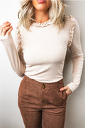 Long sleeve ruffle trim knit top in cream with brown pants