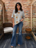 Model wearing heather gray sequin football tee with flare jeans